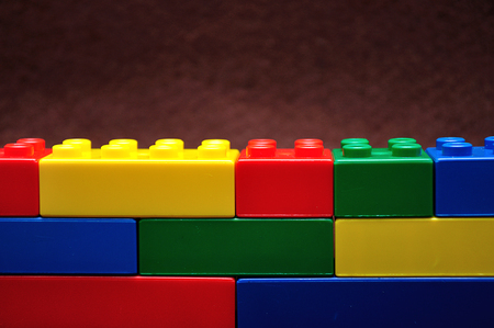 A row of color building blocks built as a wallの写真素材