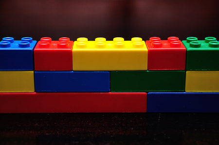 A row of color building blocks built as a wallの写真素材