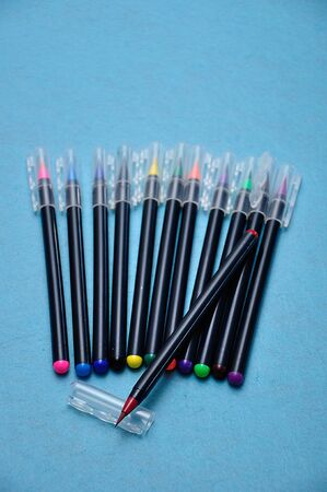 A red color pen with the rest out of focus on a blue backgroundの写真素材