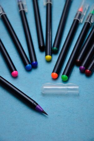 A purple color pen with the rest out of focus on a blue backgroundの写真素材