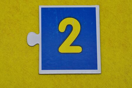 A jigsaw piece with the figure twoの写真素材