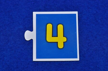 A jigsaw piece with the figure four