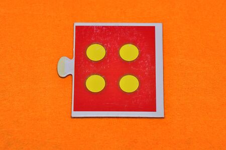 A jigsaw piece with four dotsの写真素材