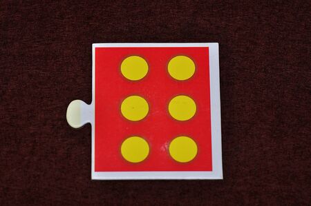 A jigsaw piece with six dotsの写真素材