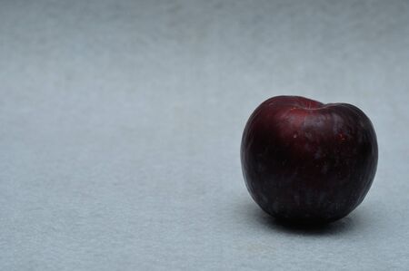 A ripe plum on a white backgroundの写真素材
