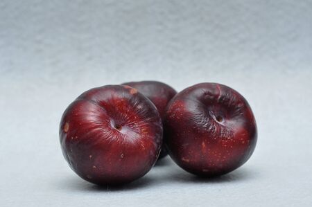 Ripe plums on a white backgroundの写真素材