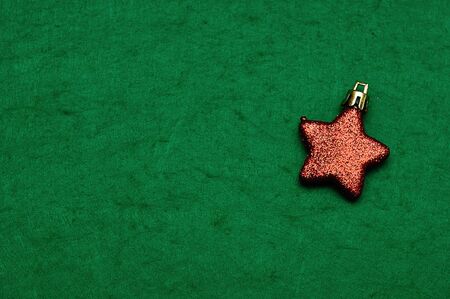 A christmas tree decoration in the shape of a red starの写真素材