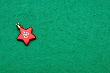 A christmas tree decoration in the shape of a red starの写真素材