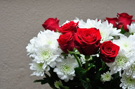 A bouquet of fresh red roses and white dahliasの写真素材