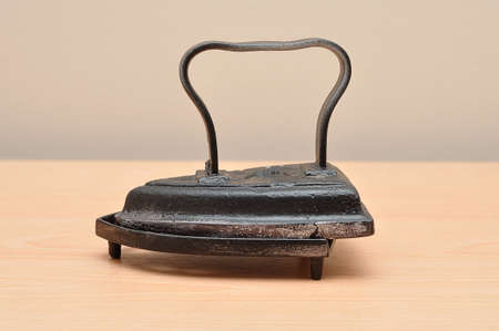An antique iron on a table on a standの写真素材