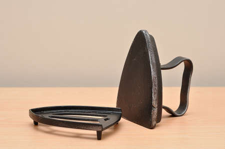 An antique iron on a table with a standの写真素材