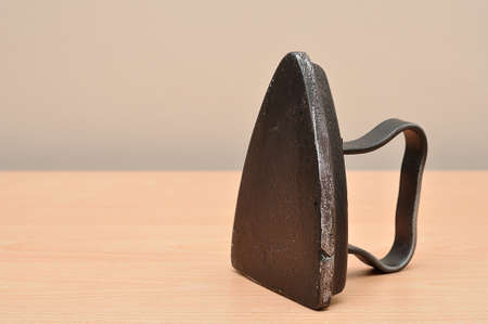 An antique iron on a tableの写真素材