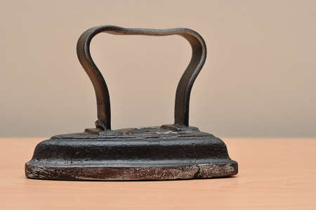 An antique iron on a tableの写真素材