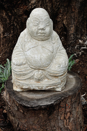 A Buddha figurine in a gardenの写真素材