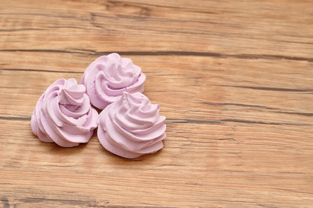 Three purple meringues on a tableの写真素材