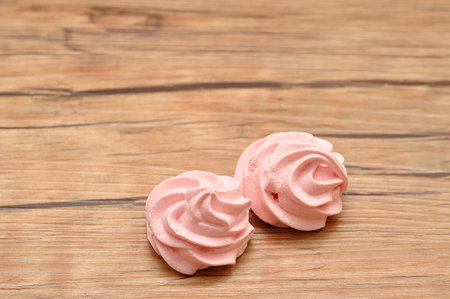 Two pink meringues on a tableの写真素材