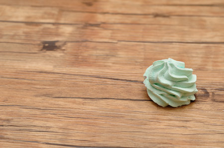 A green meringue on a tableの写真素材