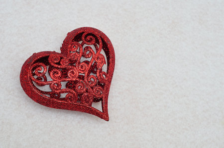 A red decorative heart isolated on a white backgroundの写真素材