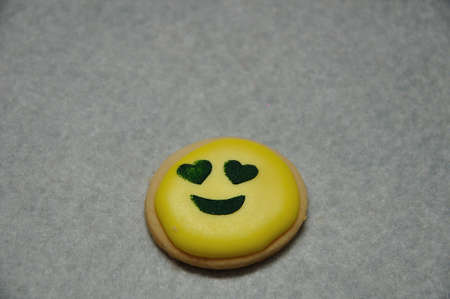 An in love emoji biscuit on a white backgroundの写真素材
