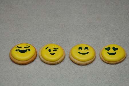 A row of emoji biscuits on a white backgroundの写真素材