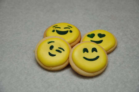 A pile of emoji biscuits on a white backgroundの写真素材