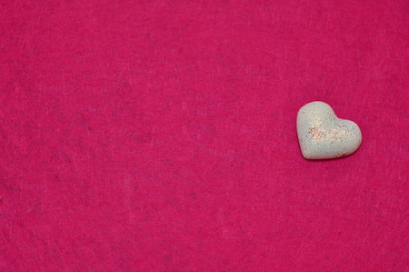A white heart isolated on a pink backgroundの写真素材