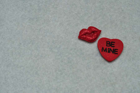 Be mine on a red heart with lips isolated on white backgroundの写真素材