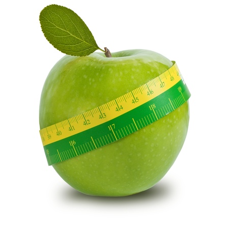Green apple with measuring tape on white backgroundの写真素材