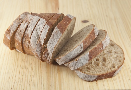 Fresh bread sliced on the wooden  board