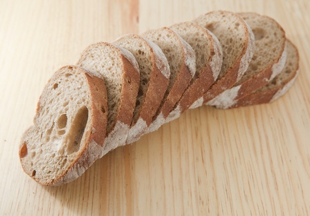 Fresh bread sliced on the wooden  board