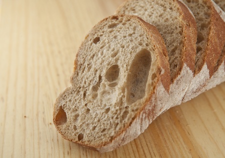 Fresh bread sliced on the wooden  board