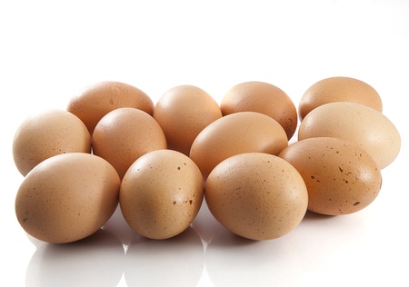 Pile of brown eggs on the white background