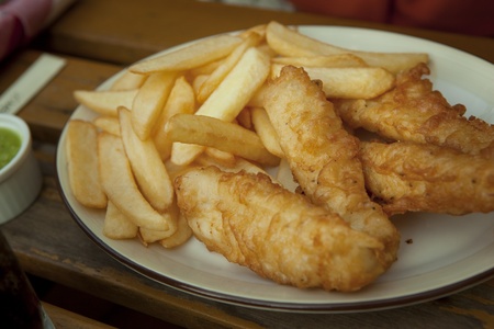 Fish and potato chips on the tableの写真素材