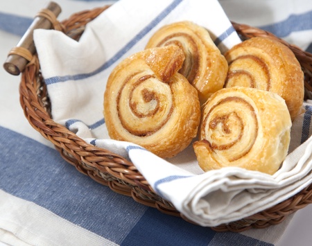 Cinnamon danish bun in the basket  on textile  background