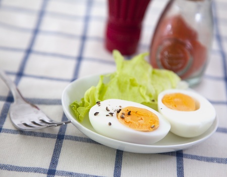 Hard boiled egg with salad on the textile backgroundの写真素材