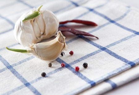 Garlic with pepper on textile backgroundの写真素材