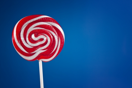 Sweets. Lollipop over blue backgroundの写真素材