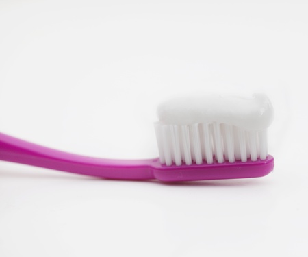 Tooth brush with paste on white background