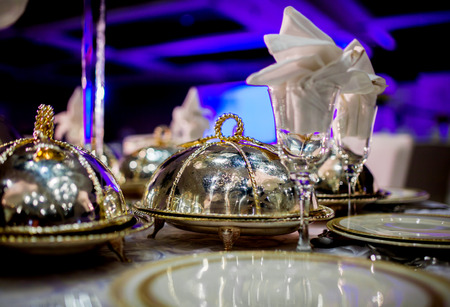 Wedding table arrangment. Luxury catering table  service with dish silverwareの写真素材