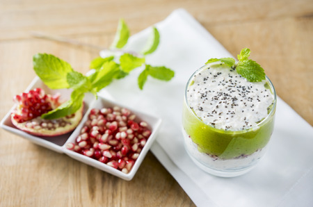 Greek yogurt with spinach smoothie on the white backgroundの写真素材