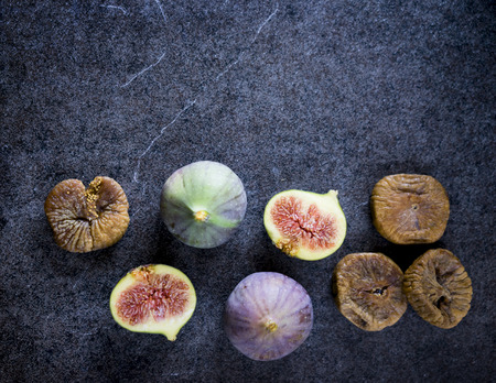 Fresh and dry figs on top of marble table. Space for textの写真素材