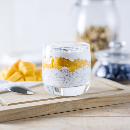 Greek yogurt with mango on the wooden tableの写真素材