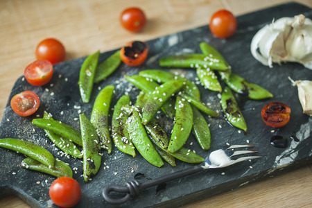 Homemade sauteed sugar snap peas with cherry tomatoの写真素材