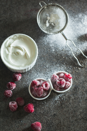 Frozen raspberry with sour cream on the tableの写真素材
