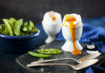 Soft boiled eggs with pears on background