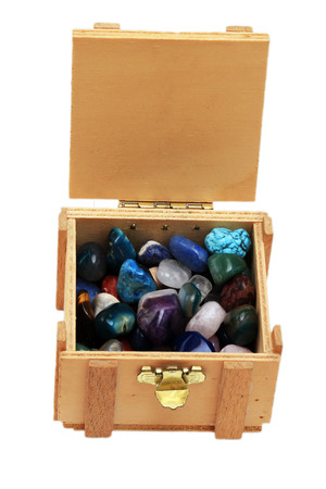 open treasure chest with jewelry isolated on whiteの写真素材