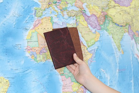 Identity document on the background of a geographical map. Passport of a citizen of the Russian Federation on the background of the card, which is written in Russian letters.の写真素材