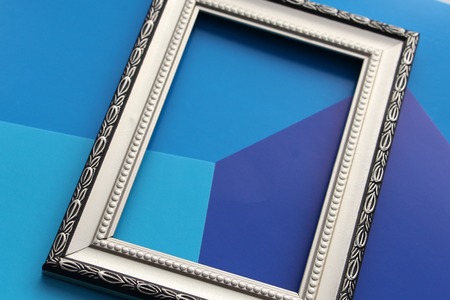 Vintage frame for photo, picture or certificate. There is nothing in the frame. Background in blue...