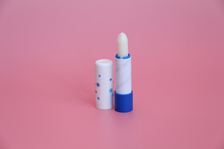 Hygienic lipstick on a pink background. Cosmetics for children, men and women. Lip care.の写真素材