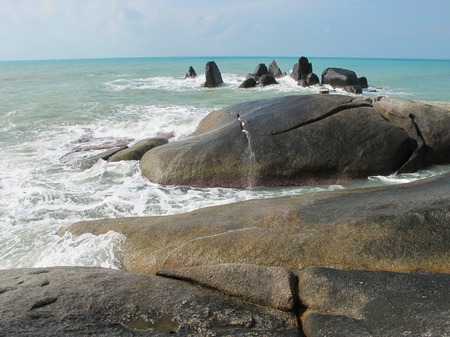 Huge stones on the beach. Boulders on the coast. On the sand are big stones.の写真素材
